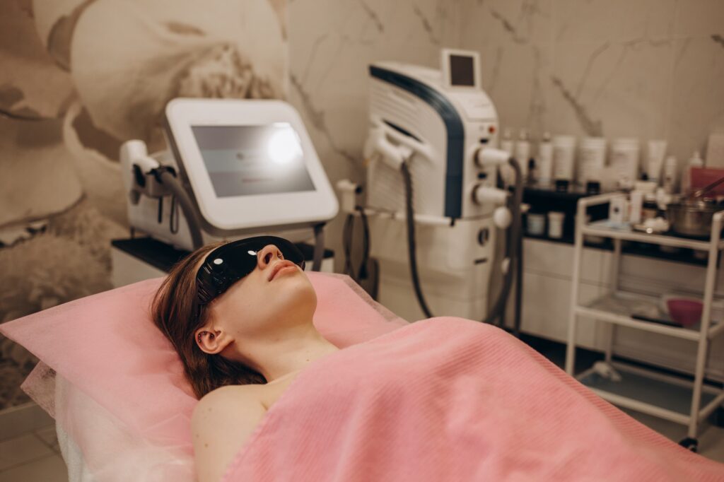 Beautiful woman waiting for armpit hair removal . Laser epilation treatment, at clinic